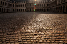 The Courtyard Of The Palace Paved With Paving Stones In The Evening Light. Louvre. Paris.