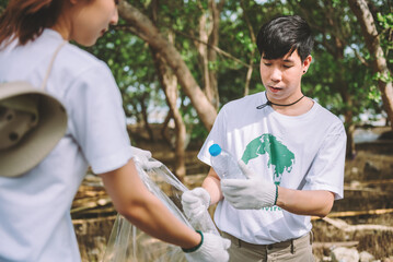 Wall Mural - Group of asian diverse people volunteer teamwork ,environment conservation,volunteer help to picking plastic and foam garbage on park area.Volunteering world environment day.