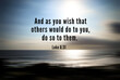 Bible verse quote - And as you wish that others would do to you, do so to them. With blurry beach background in digital motion effect and bright smooth backdrop.