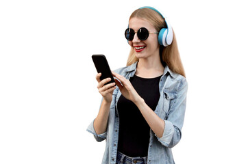 Wall Mural - Portrait of young woman with smartphone listening to music in wireless headphones isolated on white background