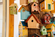 Lots Of Beautiful Multi-colored Wooden Decorative Birdhouses On The Tree. 