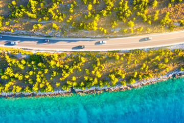 Wall Mural - view of the road along the coast from the drone. travel by car in summer time. the sea coast and the