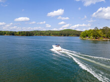 Ski Boats At Full Throttle On An Empty Lake. Large Wake Waves Behind Speed Boats.