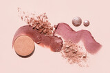 Cosmetics swatches. Peach, beige, red and coral toned styled cosmetics flat lay. Closeup colour palette. Creative concept photo of cosmetics samples. Beauty products on pastel background