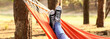 Leinwandbild Motiv Legs of young woman relaxing in hammock outdoors