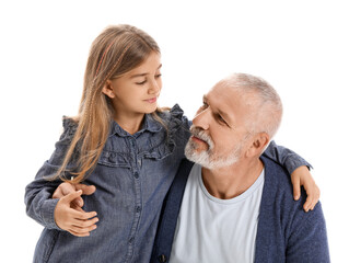 Wall Mural - Senior man with his little granddaughter hugging on white background