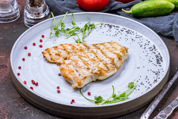 Sticker - Fried chicken breast on grey plate on dark stone table