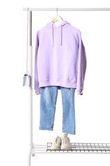 Wall Mural - Rack with female clothes, bag and sneakers on white background