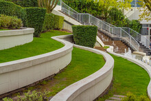 Leveled Terraces With Grass And Fountains In A City Plaza, Business Center. Urban Landscape Design.