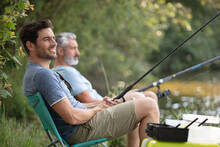 Two Contented And Relaxed Men Fishing