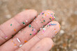 Close up side shot of microplastics lay on people hand. Concept of water pollution and global warming. Climate change idea. micro plastics concept in food and water or sea