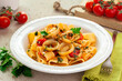 Italian pasta with calamari and tomato sauce. Calamarata is a kind of thick ring pasta paccheri, with sliced squid. Originates from Naples, the South of Italy.