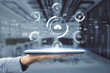 © Who is Danny - Cloud technology concept with digital tablet on human hand and virtual projection with different cloud service signs: security, loupe, computer and data on blurry office background