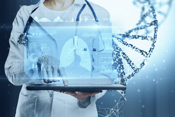 Poster - Close up of doctor hand using tablet with glowing medical hologram. Healthcare and digital transformation concept. Blurry background.