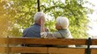 © CameraCraft - Outdoor photo of senior caucasian heterosexual couple sitting on a bench in the park enjoying beautiful weather. Gray-haired lady in warm vest touches her husband's hair. High quality photo