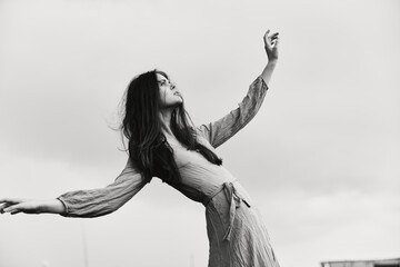 Wall Mural - portrait of a beautiful woman in dress gesturing with hands posing unaltered