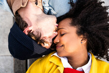 Man With Eyes Closed Kissing Girlfriend On Forehead