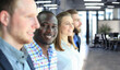 © ty - Happy smiling business team standing in a row at office