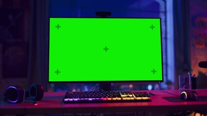 Fototapete - Gaming at Home: Empty Gaming Station with Player's Personal Computer with Green Screen Chroma Key Display Standing on a Wooden Desk in Stylish Loft Apartment with Neon Lights. Zoom In Shot.