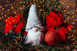 Merry christmas. Christmas composition with gnome and festive decorations on wooden background. Christmas or New Year greeting card. Noel gnome background. Christmas symbol. Happy Holidays.