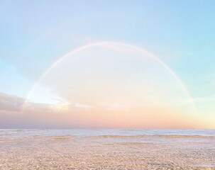 Wall Mural - rainbow at sea blue sky with pink clouds and turquoise sky pastel color summer beach holiday