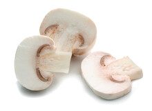 Three Pieces Of Champignon Mushrooms Cut And Placed On A White Surface
