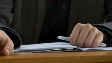 Student Hand Finger Tapping Closeup. Young Man Taps His Fingers On A Table