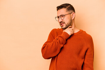 Young hispanic man isolated on beige background touching back of head, thinking and making a choice.