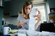 © Lazy_Bear - Woman looking at paper bill and counting expenses, Planning budget and home finance management