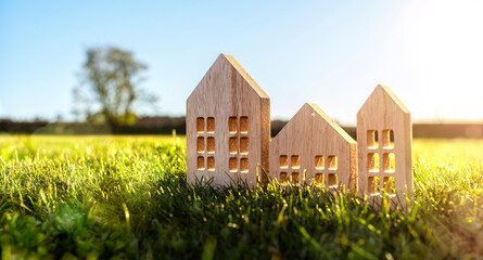 Green ecological house in empty field at sunset concept for construction and real estate