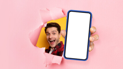 Poster - Excited guy showing white empty smartphone screen through torn paper