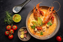 Tom Yam Kung Spicy Thai Soup With Shrimp, Seafood, Coconut Milk And Chili Pepper In A Bowl, Top View With Copy Space