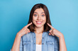 Photo of pretty adorable lady dressed denim shirt pointing fingers white teeth isolated blue color background