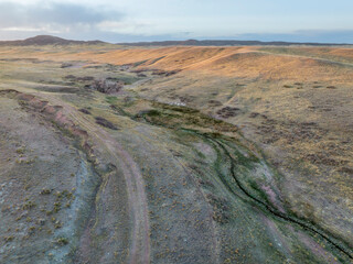 Wall Mural - sunset over a stream in Colorado prairie - early spring aerial view