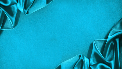 beautiful light green blue silk satin surface. soft folds on shiny fabric. luxury teal background wi