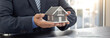 © Puwasit Inyavileart - Sales manager or real estate agent prepares to hand over the keys and the house together with the insurance to the customer, Attention to property services and insurance concept.