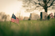 gravestones in the cemetery with a flag