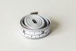 © Austockphoto - sewing tape measure on white copy space