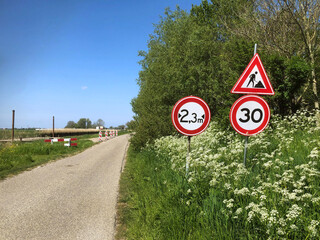 Wall Mural - Traffic signs near roadside. Work in progress. Narrow road. Netherlands. 30 kilometer.