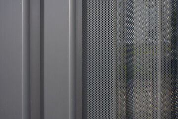 Wall Mural - Texture of a perforated and corrugated sheet metal aluminum facade.