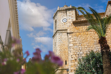 Bell tower and church of Lliber on a sunny spring day, in Alicante (Spain)