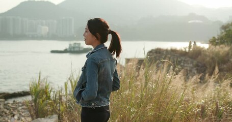 Wall Mural - Woman look at the sea view at sunset time