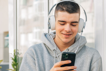 Wall Mural - young man with headphones and mobile phone