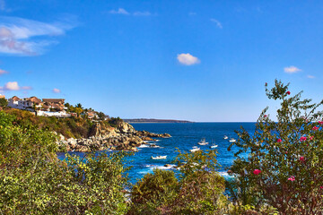 coast at sunny day with beautiful sea and ships in the ocean with blue sky in puerto escondido oaxaca 