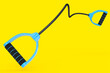 Hand expander or resistance band with rubber handle isolated on yellow.