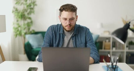 caucasian software developer in casual attire programming codes while distantly working from home. c