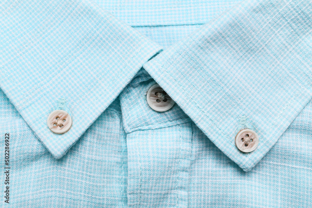 Closeup view of buttons on blue stylish shirt