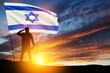 Silhouette of soldier saluting with Israel flag against the sunrise in the desert. Concept - armed forces of Israel.