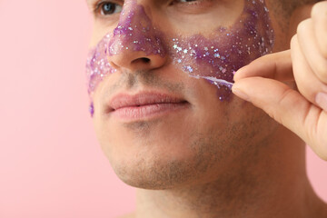 Sticker - Handsome man with glitter mask on pink background, closeup