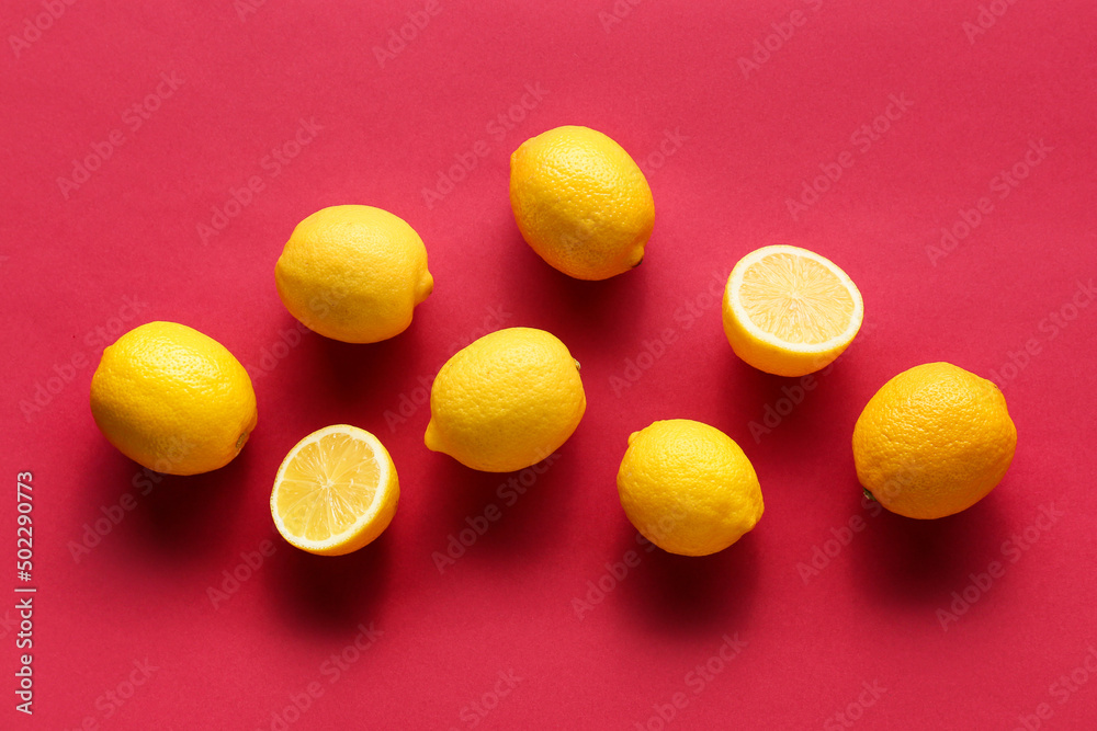 Ripe lemons on red background, top view